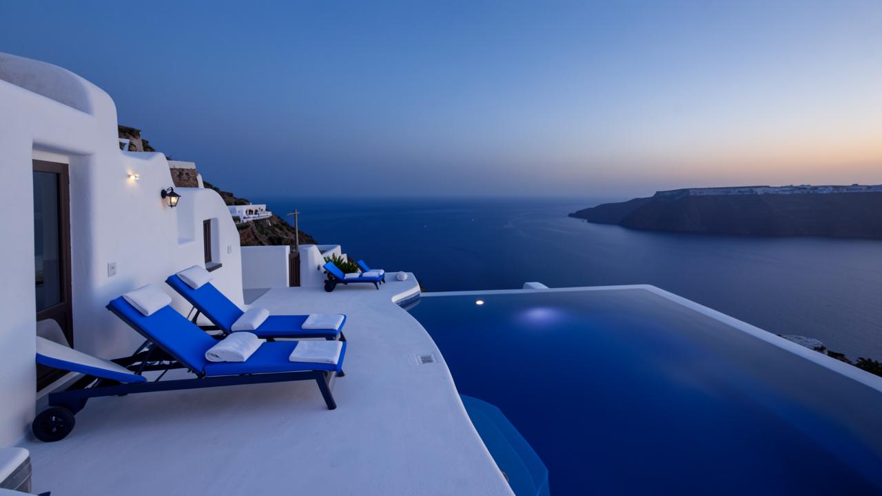 Infinity pool at dusk, still water meeting the horizon