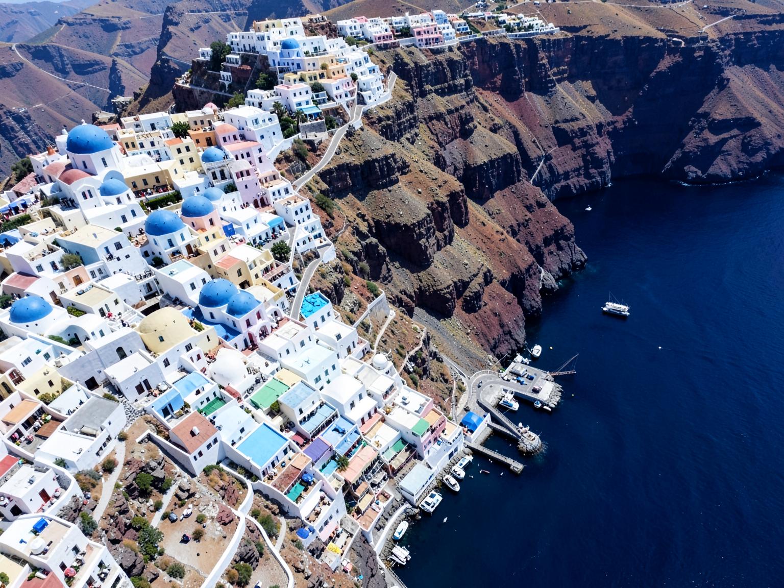 Aerial view of the whitewashed village and harbour below the villa
